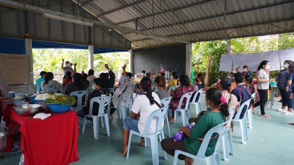 Holt's partner empowers families in Thailand through job skills training, like the families pictured here at an HSF job fair