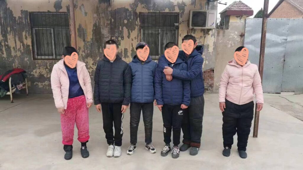 Children at an orphanage in China wear coats donated by an adoptee