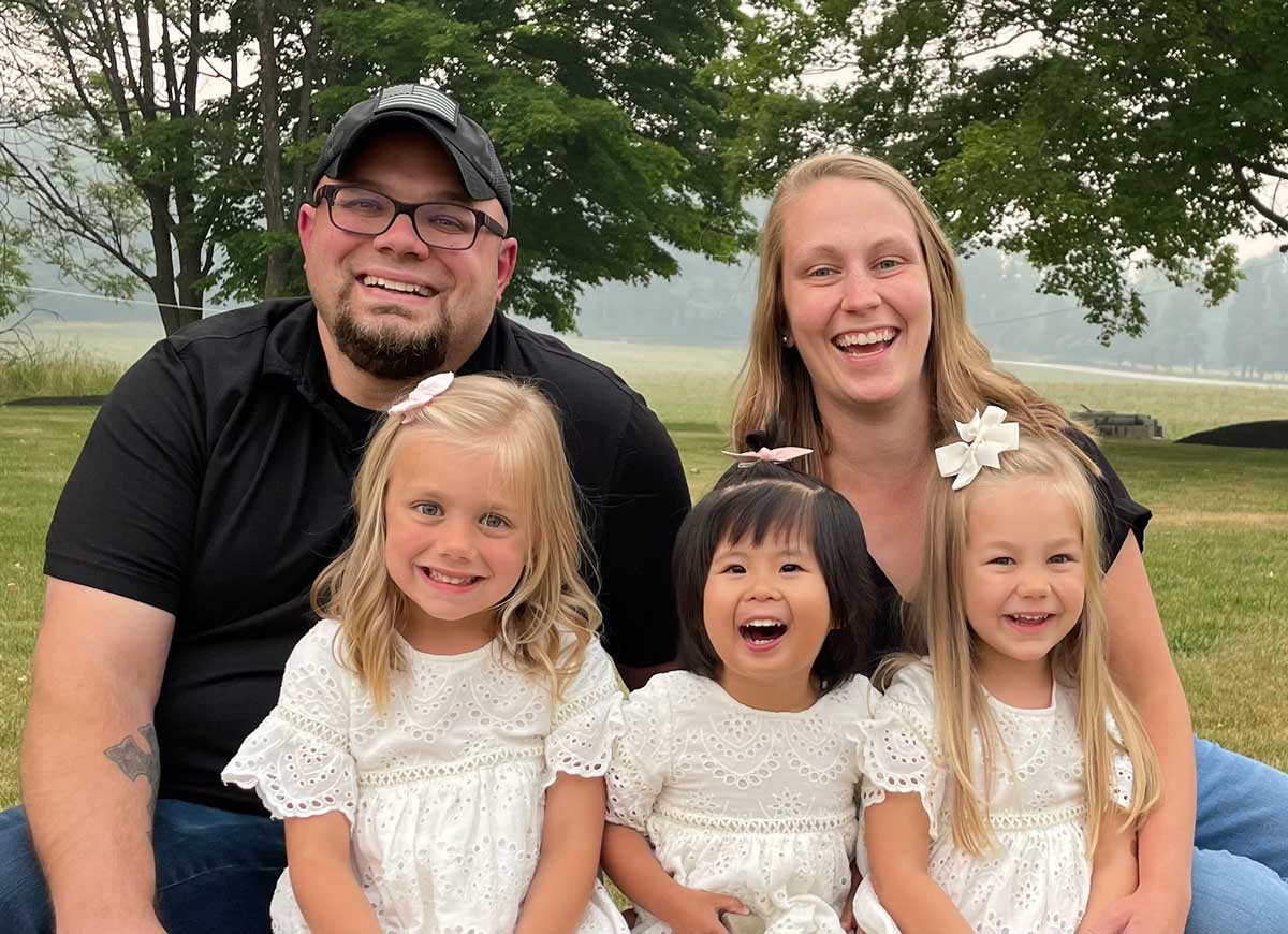 Breure family adoption agency review of Holt after adopting daughter from Taiwan in 2023, shown with their other two daughters outside