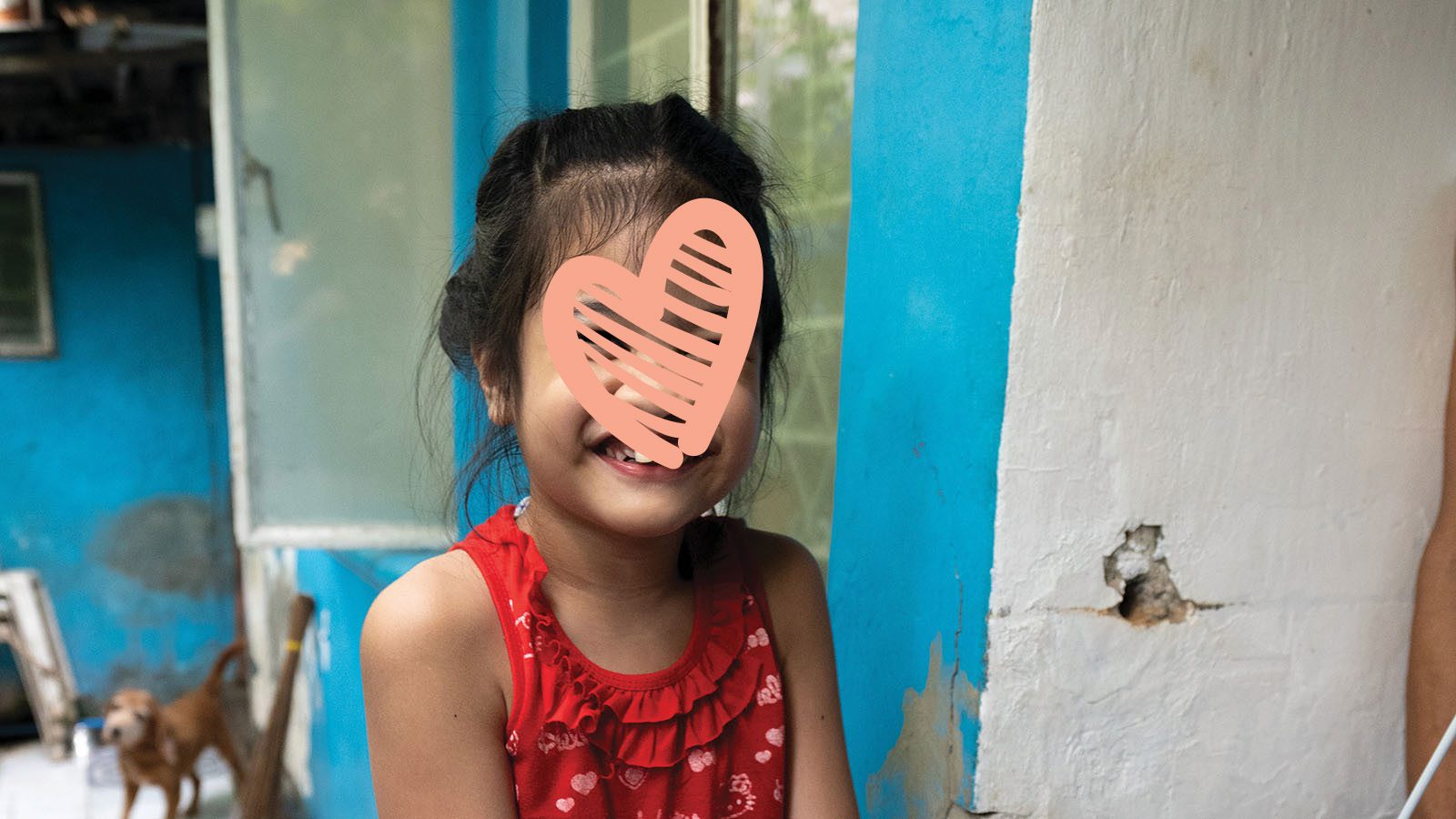 Little girl in red tank top smiles big