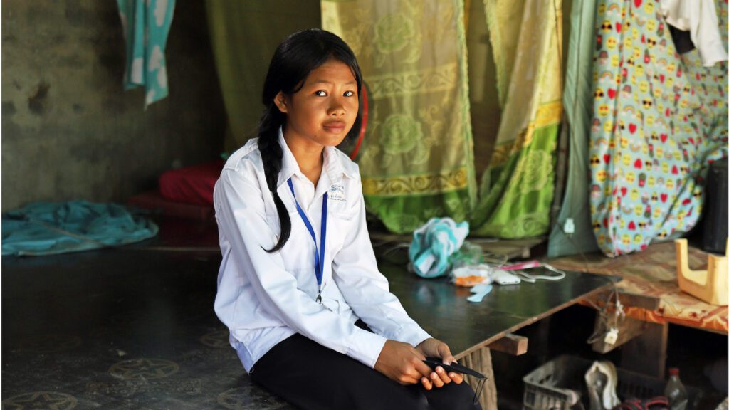 School girl sitting in her house in Cambodia