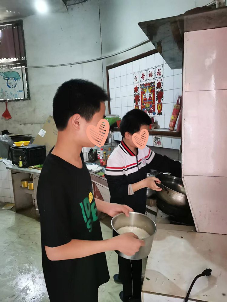 Two boys cook together in the kitchen