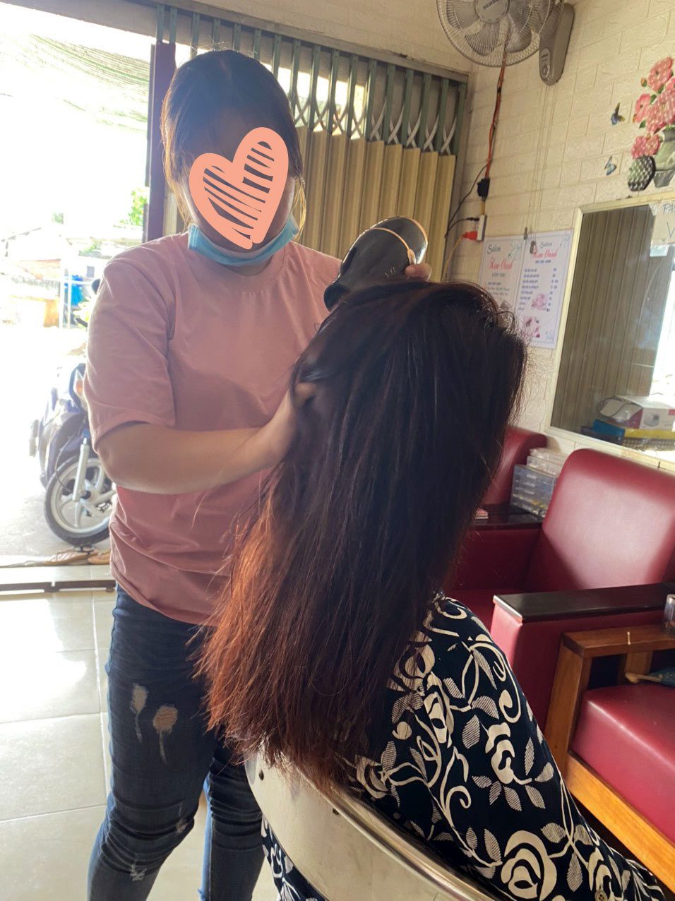 Human trafficking in Vietnam, a survivor works as a hairdresser through Holt Vietnam's economic empowerment program.