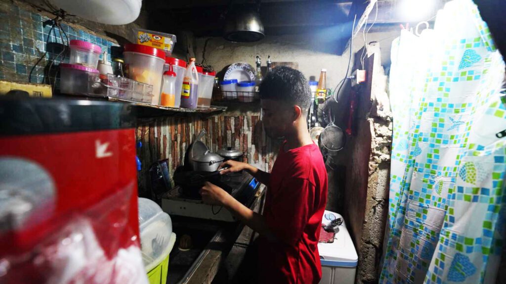 Sponsored student Gabriel cooks in his family's small kitchen.