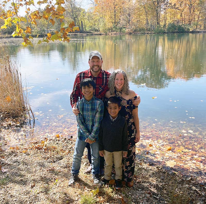 Family portrait in autumn in front of lake