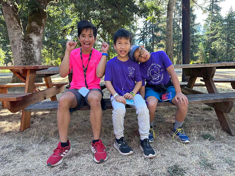 Boys smile and look silly on picnic table