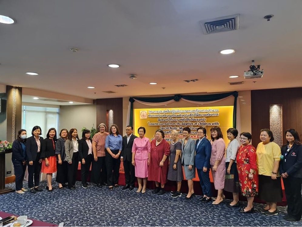 Large group of people at conference pose for camera