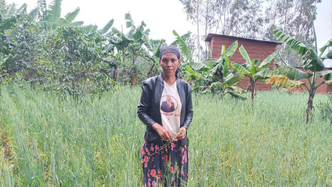 Woman stands in field