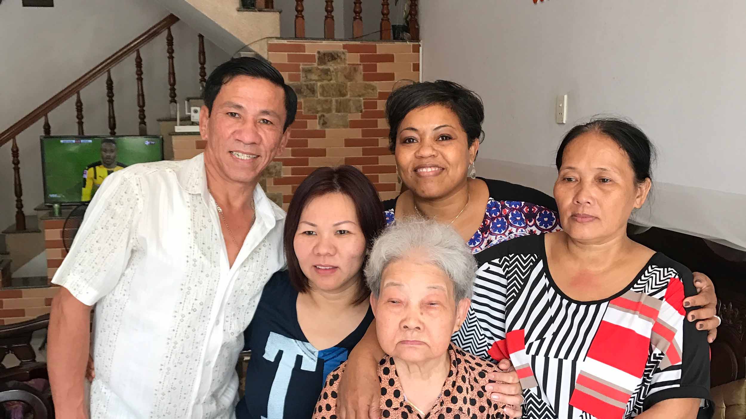 Family takes a picture in a living room