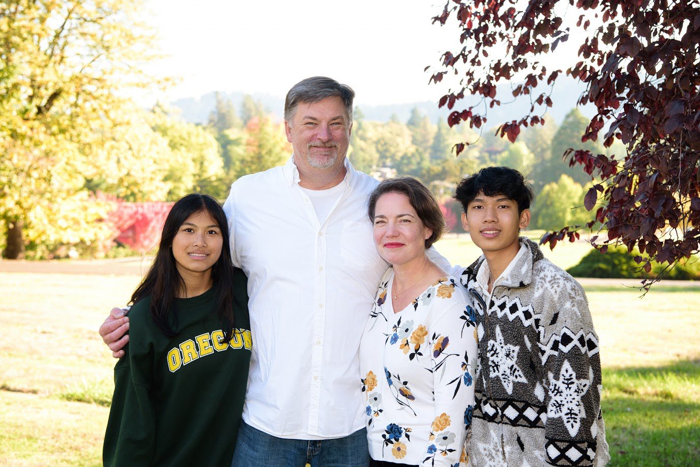 Adoptive parents with their two teenage children adopted from Thailand