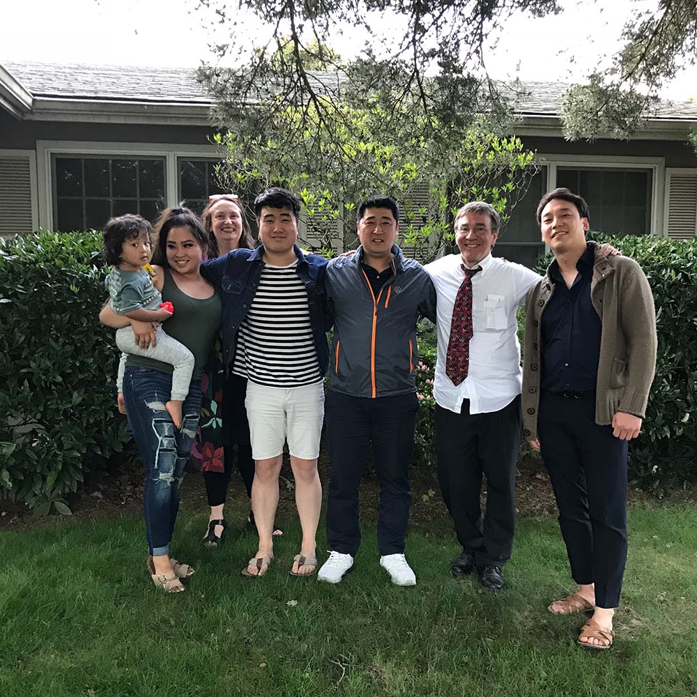 Group of people take a family picture on the lawn