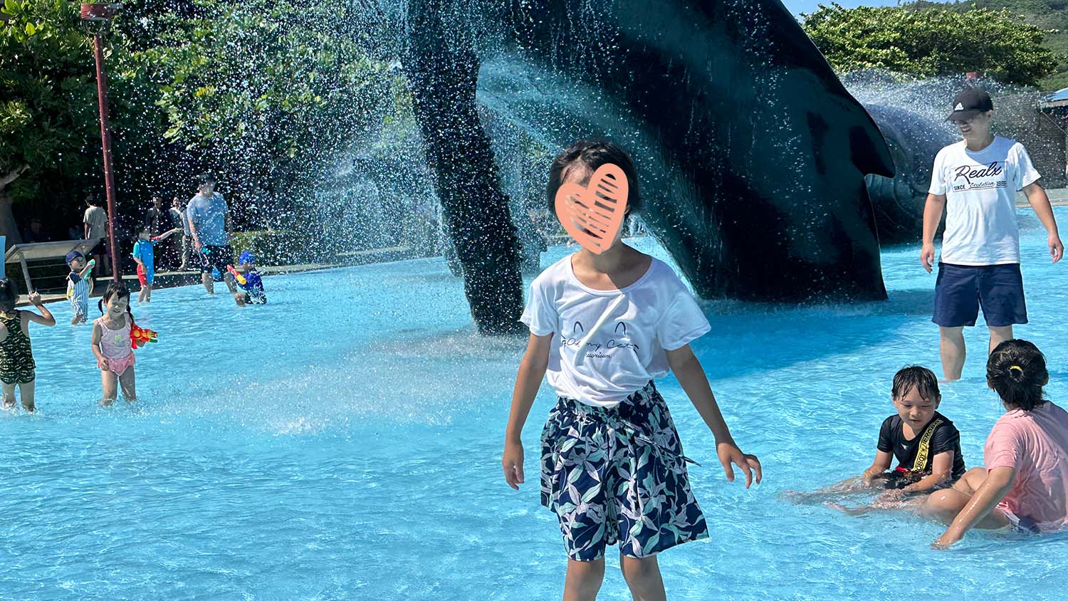 Little girl laughs in water at a water park
