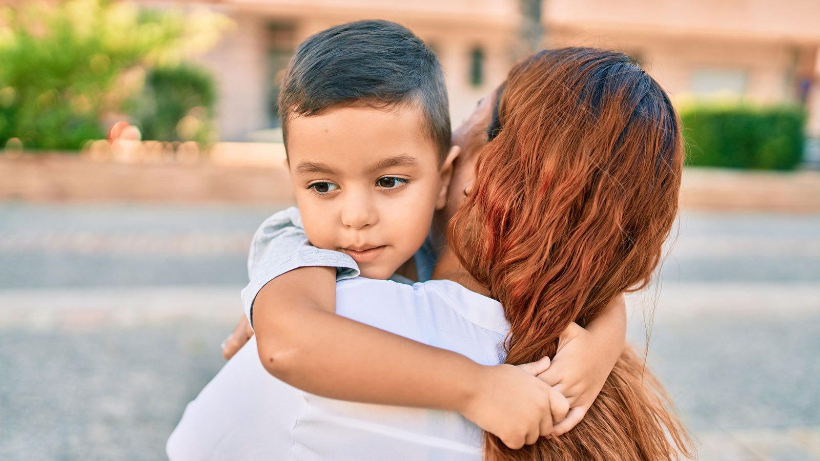 Child with arms around mom