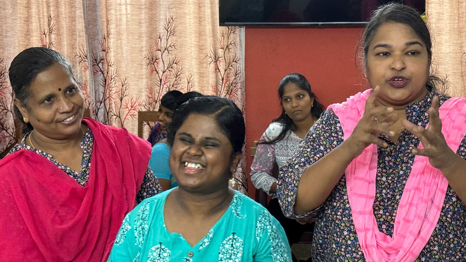 Caregivers and a teen girl with disabilities in India