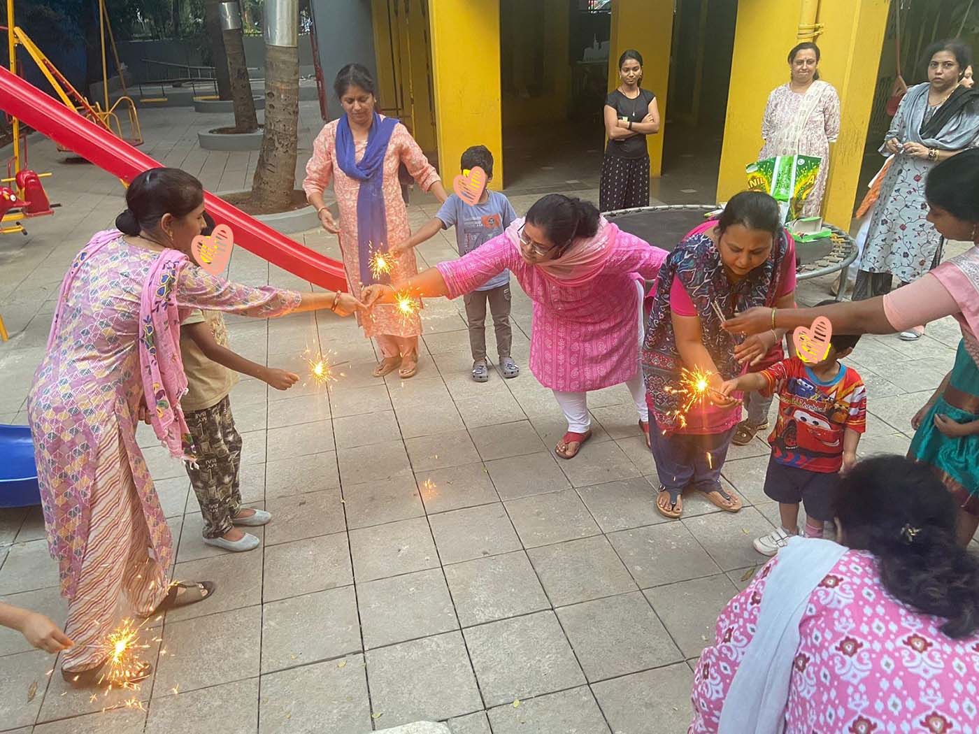 A group of women and children in India play with sparklers for Diwali