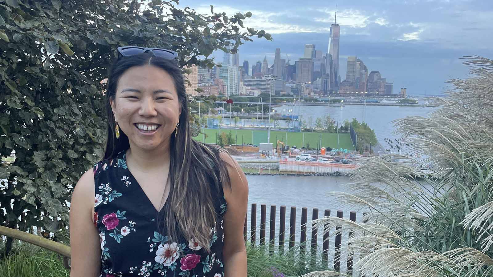 Chinese adoptee Katelyn Dixon smiles as she poses at a scenic overlook of the city