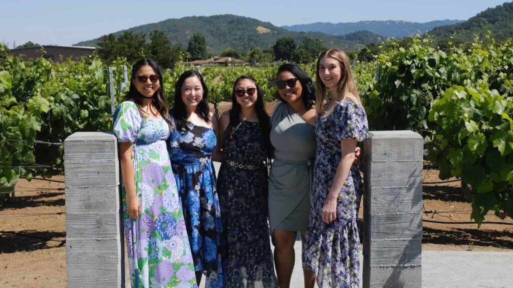 Katelyn Dixon with friends at a wedding outdoors