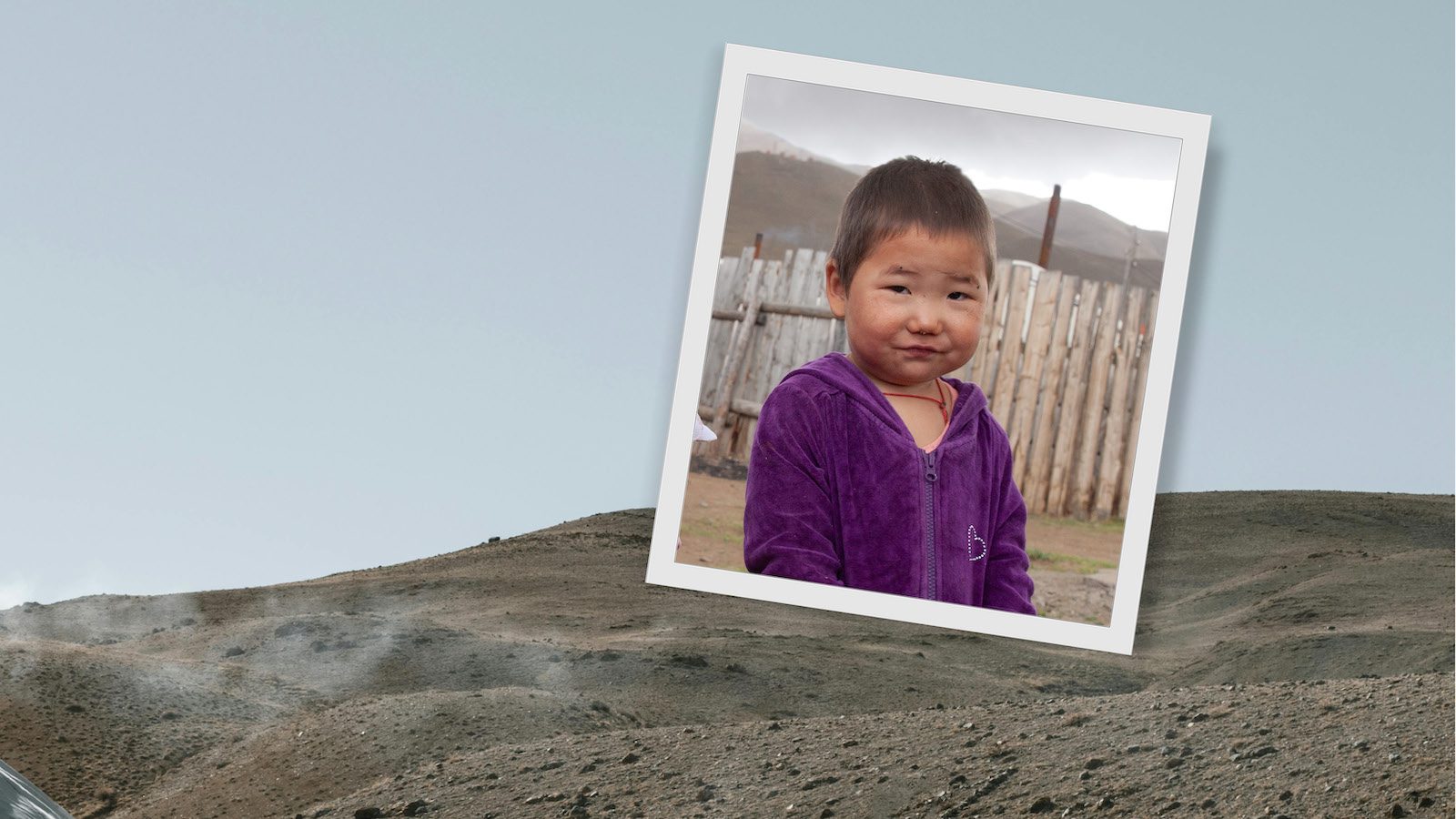 Little girl wearing a purple coat while standing in the cold in Mongolia.