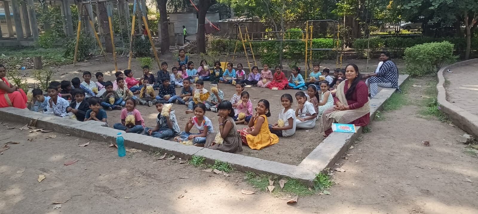 Group of school children seated outside
