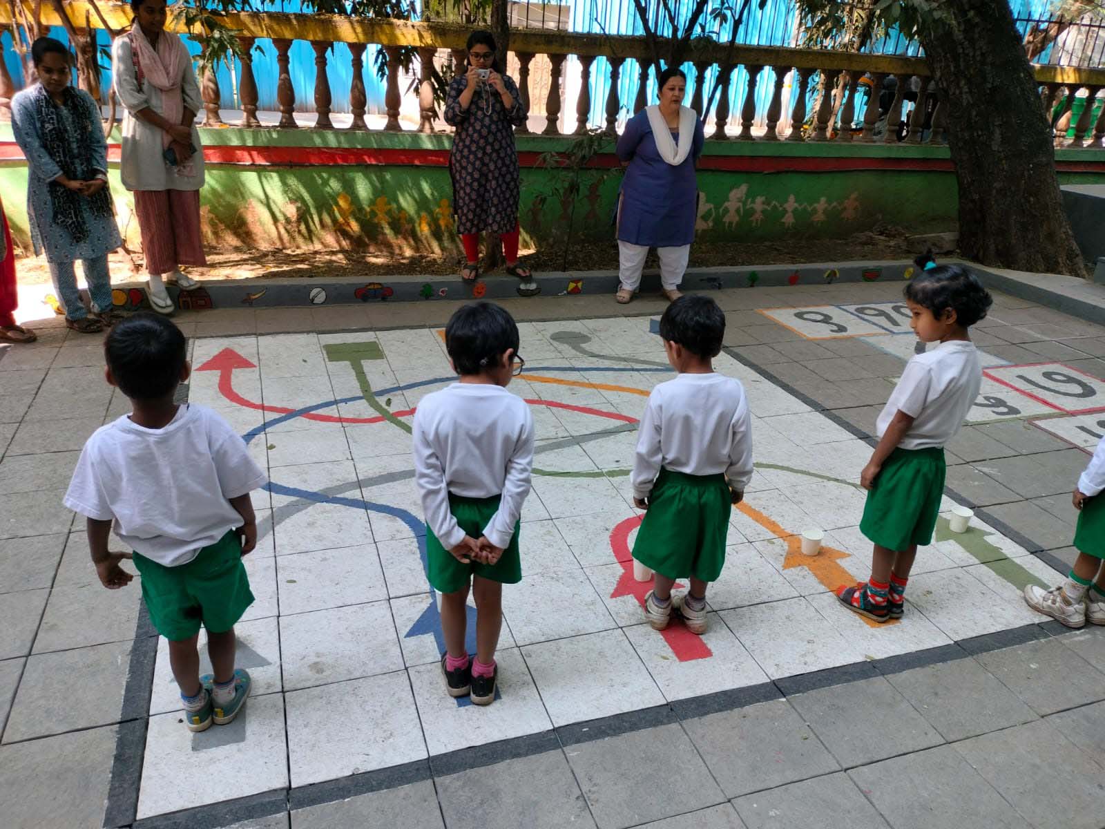 A group of little girls and boys play games outside