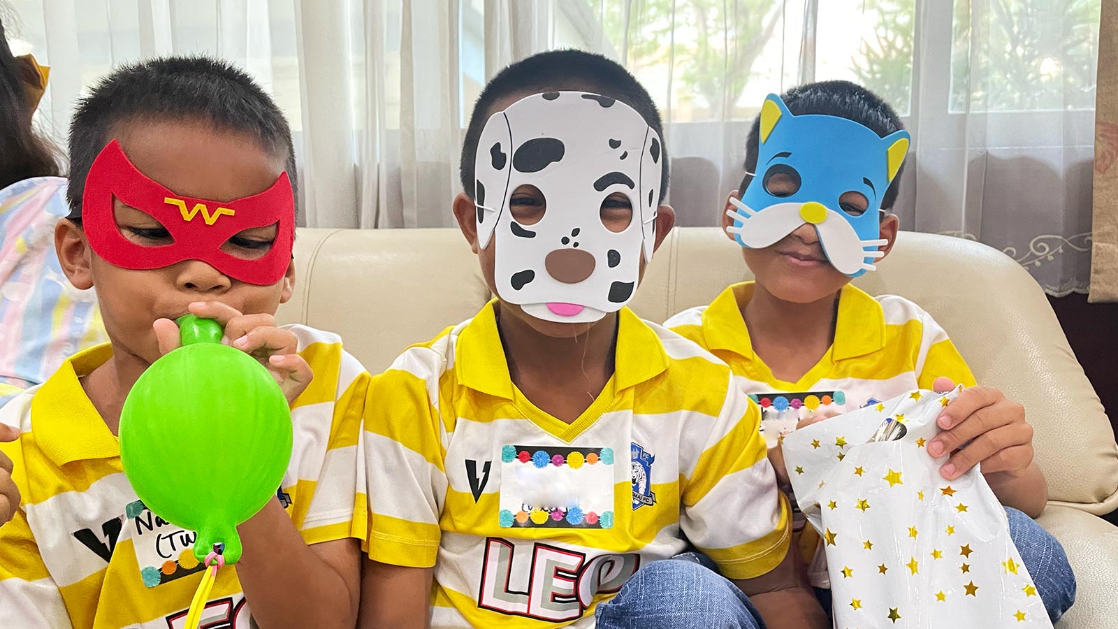 Boys in Thailand Special Needs Program wearing playful masks