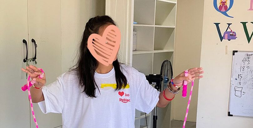 a girl holds a jump rope