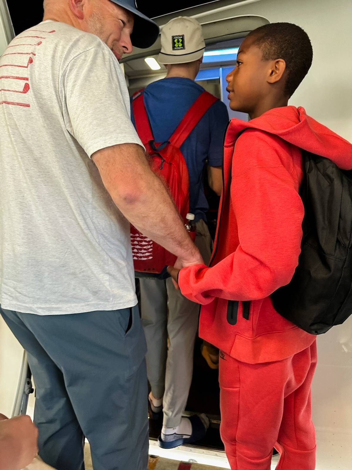 a child boards a plane with his adoptive family.
